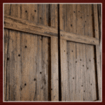 Rustic wooden barn door with dark accents.