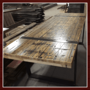 A wooden table with a glass top in a workshop.