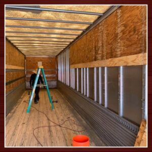 inside of a trailer with salvaged wood walls